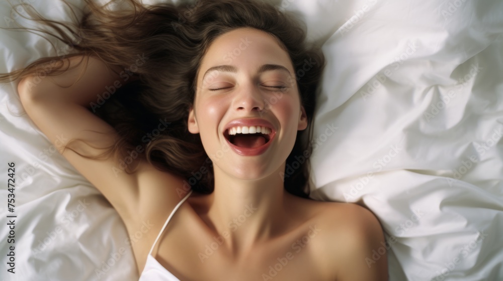 A beautiful female is enjoying and feels good. Woman's face during an orgasm in bed. Women's pleasure. A beautiful female is enjoying and feels good. Woman's face during an orgasm in bed. Women's pleasure.