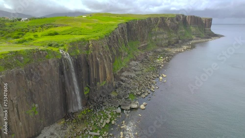 The drone aerial footage of Kilt Rock and Mealt waterfall. The waterfall from Loch Mealt falls 55 metres to the sea. Behind is Kilt Rock, 90 metres tall. photo