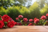 empty wooden table on a blurred background of a garden with blooming red roses. a mockup for the display of your product.