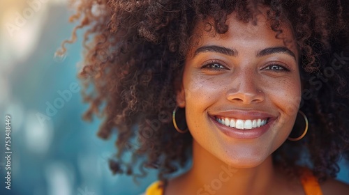 Close-up of a woman with curly hair smiling happily