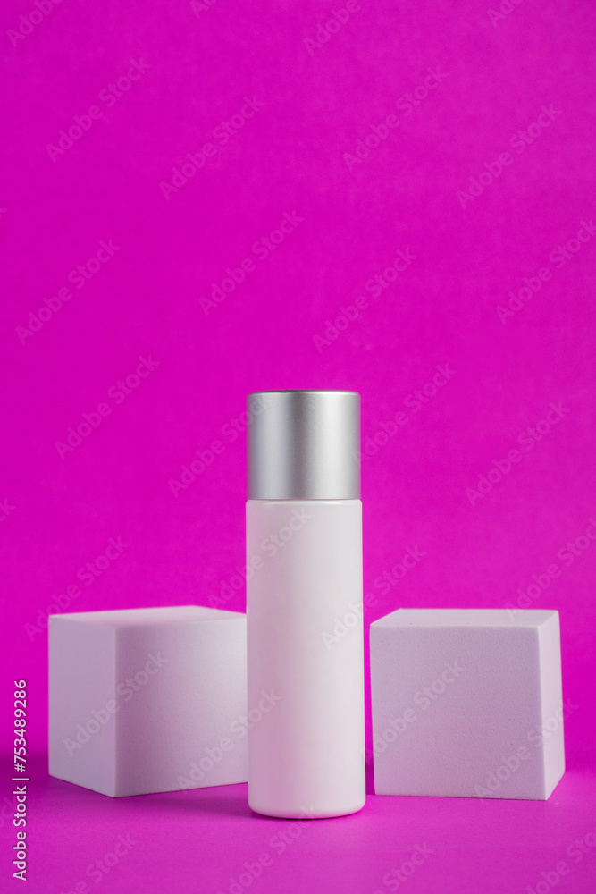 Plastic white tube for cream or lotion. Skin care or sunscreen cosmetic with stylish props on purple background Plastic white tube for cream or lotion. Skin care or sunscreen cosmetic with stylish props on purple background