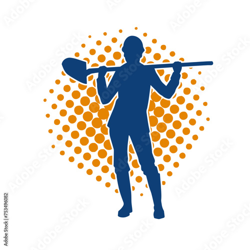 Silhouette of a female wearing worker costume in action pose with shovel tool.