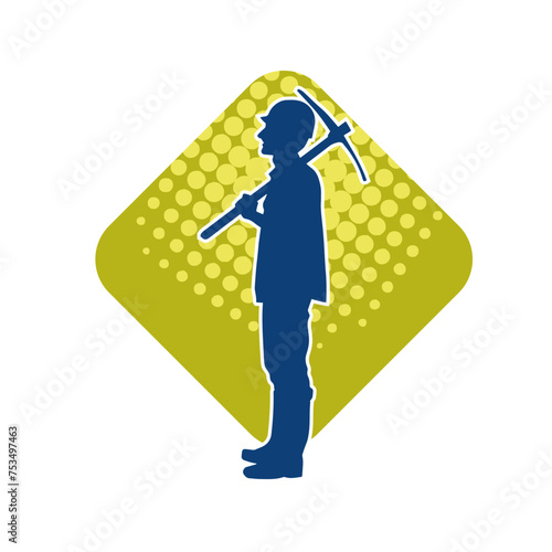 Silhouette of a man in worker costume carrying pick axe tool in action pose. Silhouette of a miner in action pose with pick axe tool.