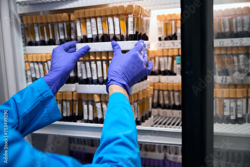 Laboratory assistant takes blood samples in test tubes photo