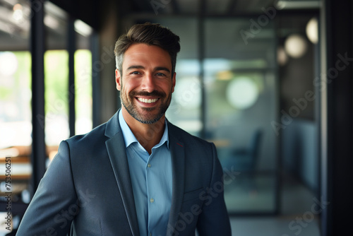 Portrait of a smiling handsome businessman, professional and confident looking man in suit at office, Successful matured businessman looking at camera, positive looking office manager wearing a jacket