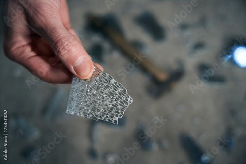 Worker holds a piece of triplex glass in his hands