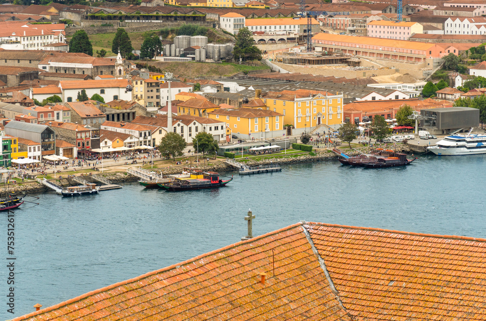 Aerial view of the Douro River and the promenade of Porto with the Rabelas, classic boats for tourist routes of the 6 bridges and the Gaia cable car station on the right.