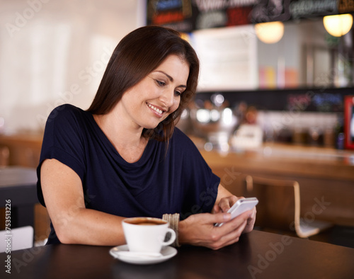 Happy woman, cafe and typing with phone for communication, social media or networking at coffee shop. Female person with smile on mobile smartphone for online chatting or texting at indoor restaurant