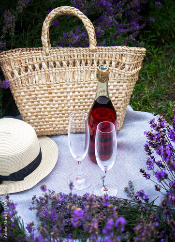 Fototapeta Naklejka Na Ścianę i Meble -  two glasses and pink wine in a lavender field. Violet flowers on the background