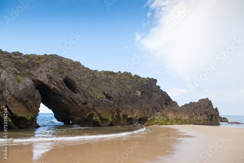 Rock arch on San Antolin beach, Spain photo