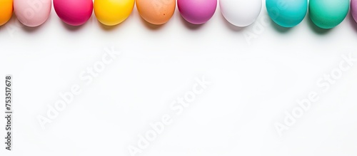 Vibrant Easter Celebration: Colorful Easter Eggs Arranged in a Festive Row on Bright White Background