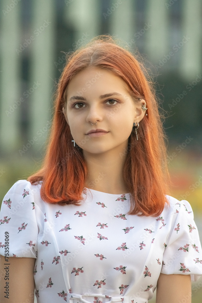 Portrait of a young beautiful red-haired girl in a dress in a summer park. Portrait of a young beautiful red-haired girl in a dress in a summer park.