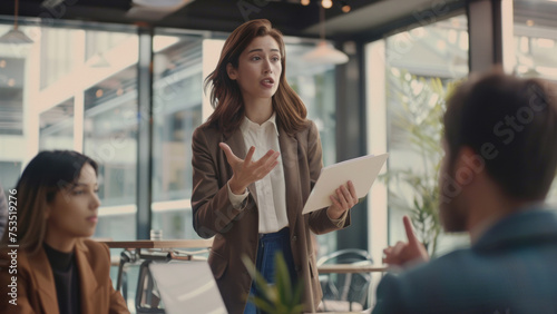 Wallpaper Mural Businesswoman actively engaging colleagues during a focused group discussion. Torontodigital.ca