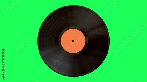 LP old vinyl record spinning on the green screen. Top view.