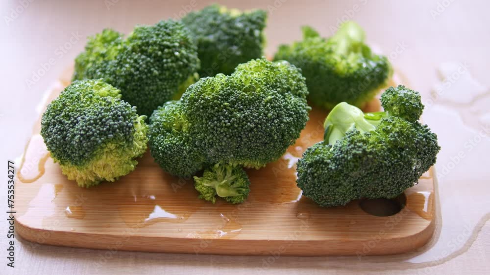 Another piece of broccoli is placed on cutting boar showing off vibrant green. Broccoli rest ready for preparatio offering its wholesome goodness Explore versatility of broccoli for culinary creations Another piece of broccoli is placed on cutting boar showing off vibrant green. Broccoli rest ready for preparatio offering its wholesome goodness Explore versatility of broccoli for culinary creations