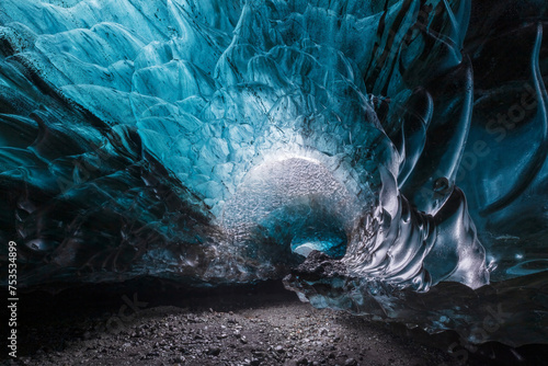 Beautiful blue glacial ice cave in spiral shape in Vatnajokull National Park in Iceland photo