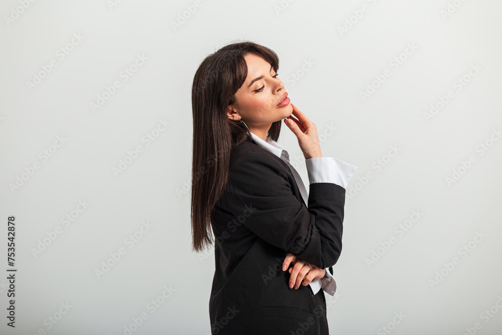 Beautiful fashionable business lady in fashion clothes with a jacket and shirt on a white background in the studio. Pretty chic woman Beautiful fashionable business lady in fashion clothes with a jacket and shirt on a white background in the studio. Pretty chic woman