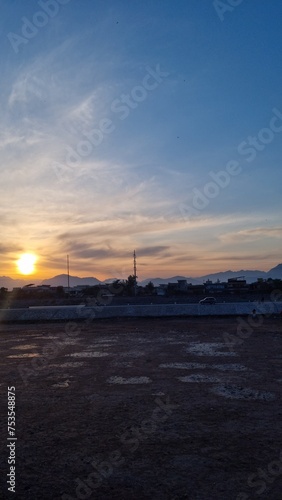 sunset over the muddy terrain and housee photo