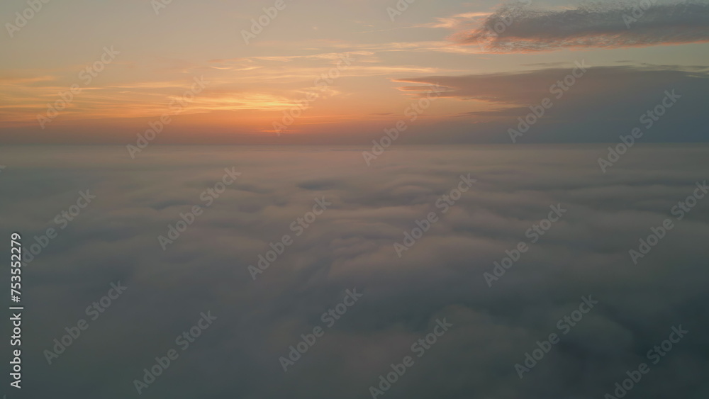 Fototapeta premium Amazing sunrise fluffy clouds aerial view. Golden horizon at summer morning