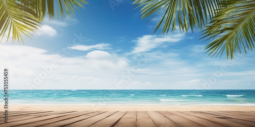 Ideal holiday scenery with a vacant wooden table  summer ocean waves  palm leaves  and a cloudy blue sky.