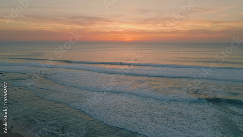 Peaceful ocean evening dusk with golden cloudy sky over endless horizon aerial  © stockbusters
