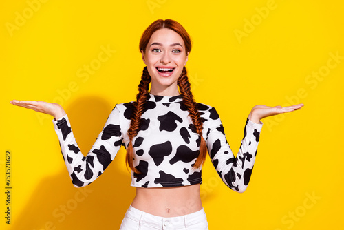 Photo of excited funky woman wear cow skin top plump lips showing arms scales empty space isolated yellow color background