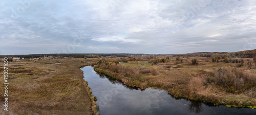 Aerial panorama on autumn river valley with clouds