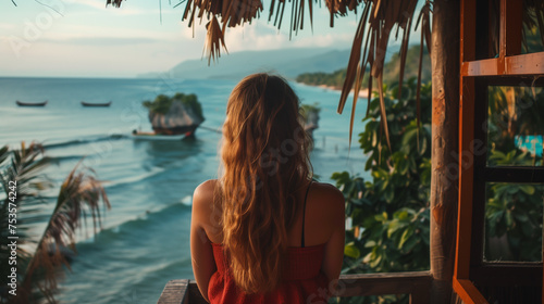 Woman Admiring Ocean View From Balcony photo