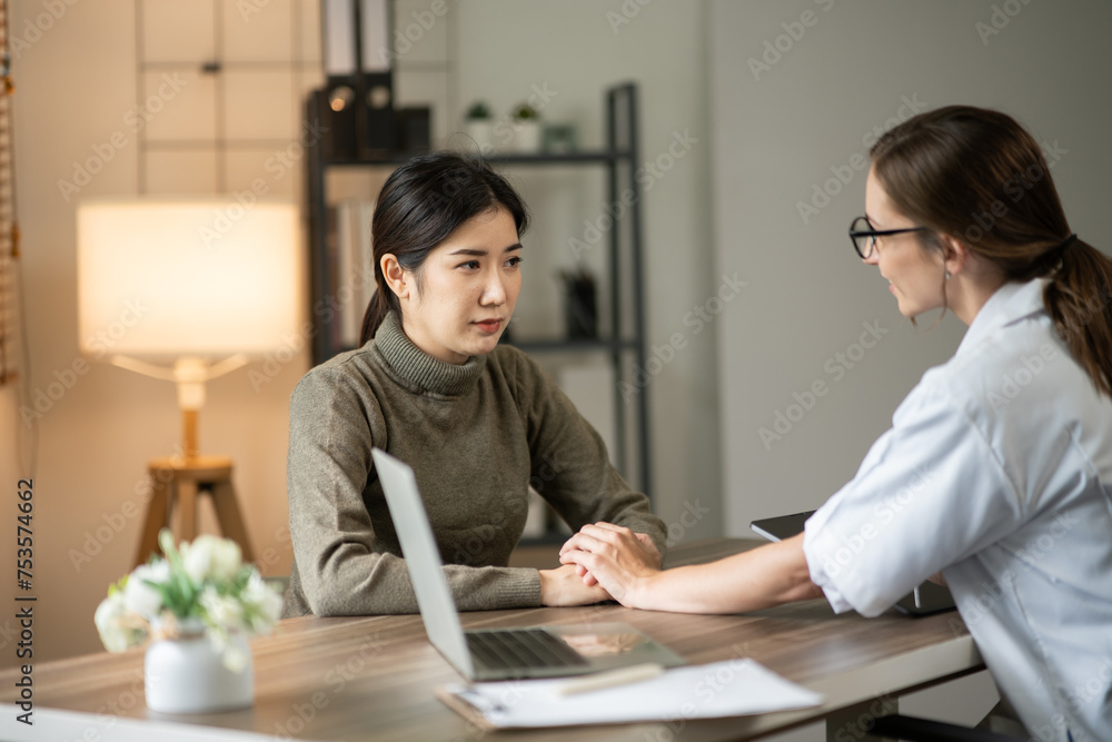 Female doctor sitting at work looking at the history of patients in the clinic or in the hospital Female doctor sitting at work looking at the history of patients in the clinic or in the hospital
