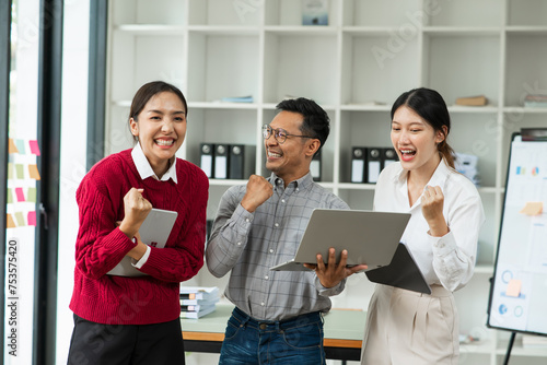 Asian business presents to explain the graph work on the whiteboard. Consulting, discussing, exchanging knowledge.