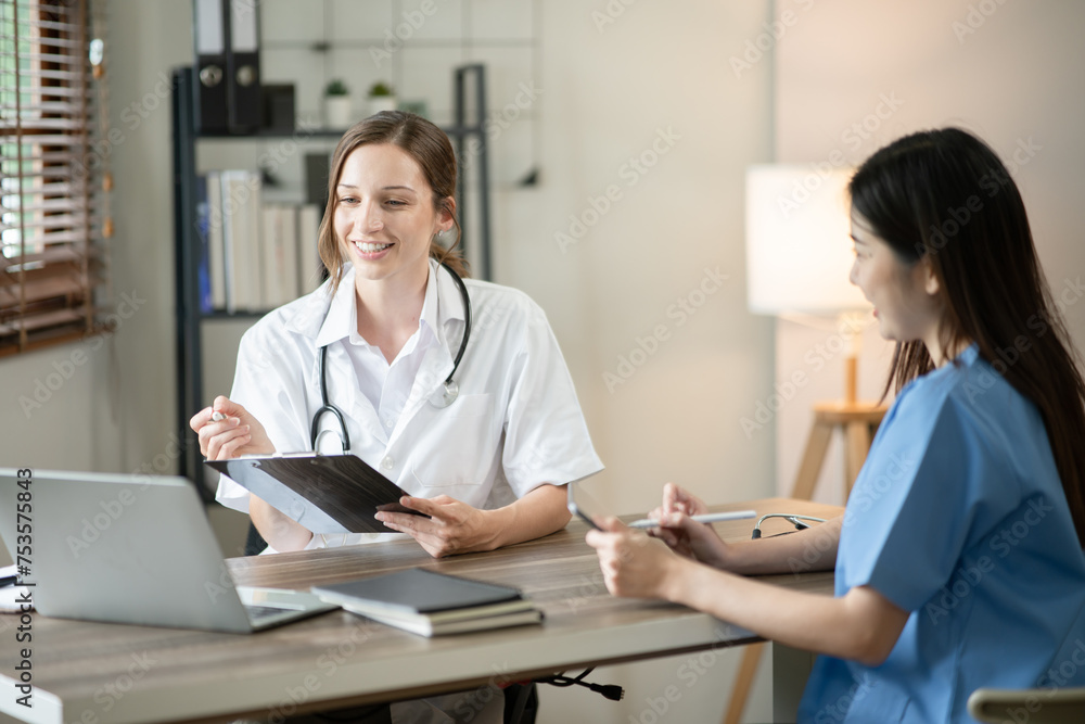 Female doctor sitting at work looking at the history of patients in the clinic or in the hospital Female doctor sitting at work looking at the history of patients in the clinic or in the hospital