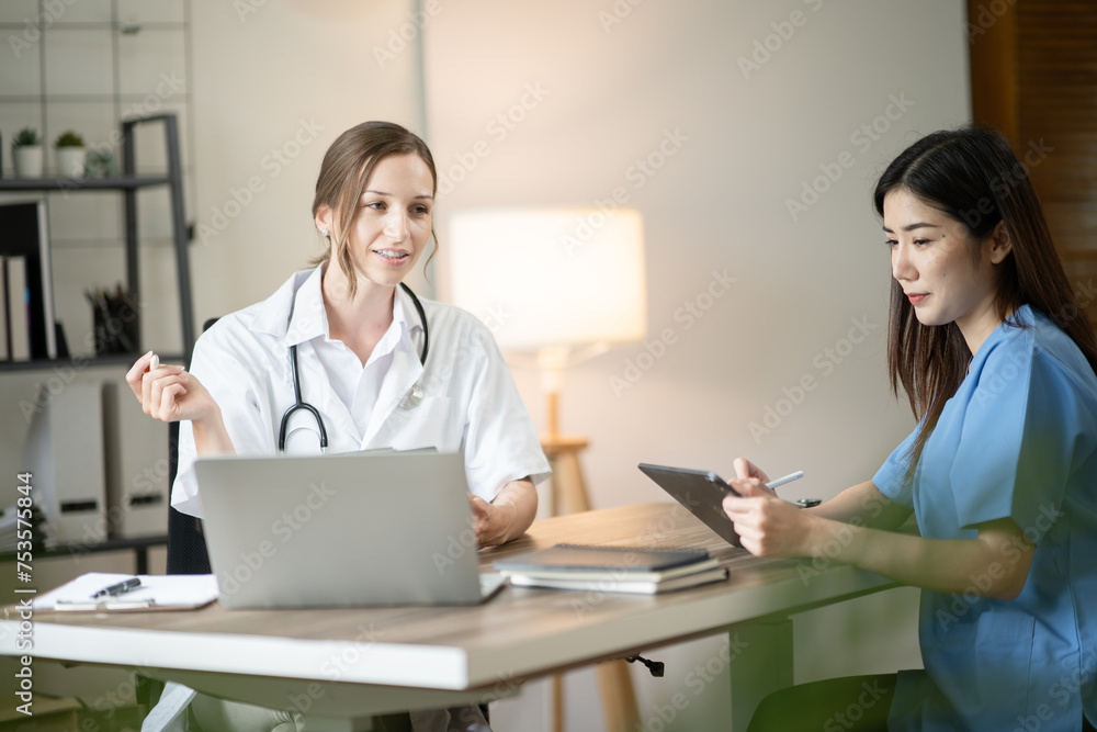 Female doctor sitting at work looking at the history of patients in the clinic or in the hospital Female doctor sitting at work looking at the history of patients in the clinic or in the hospital