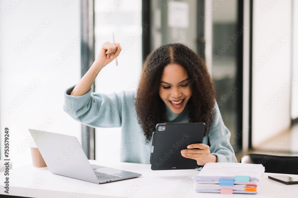 Business woman are delighted and happy with the work they do on their tablet, laptop and taking notes Business woman are delighted and happy with the work they do on their tablet, laptop and taking notes
