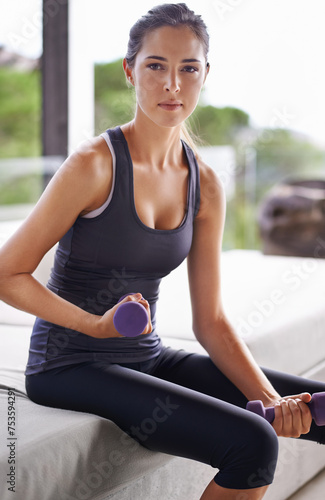 Fitness, dumbbells and portrait of woman for health, wellness and physical training in gym. Exercise, sitting and weights with young female person for workout, muscle gain or strength challenge