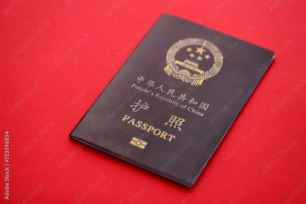 Red passport of People Republic of China. PRC chinese passport on bright background close up Red passport of People Republic of China. PRC chinese passport on bright background close up