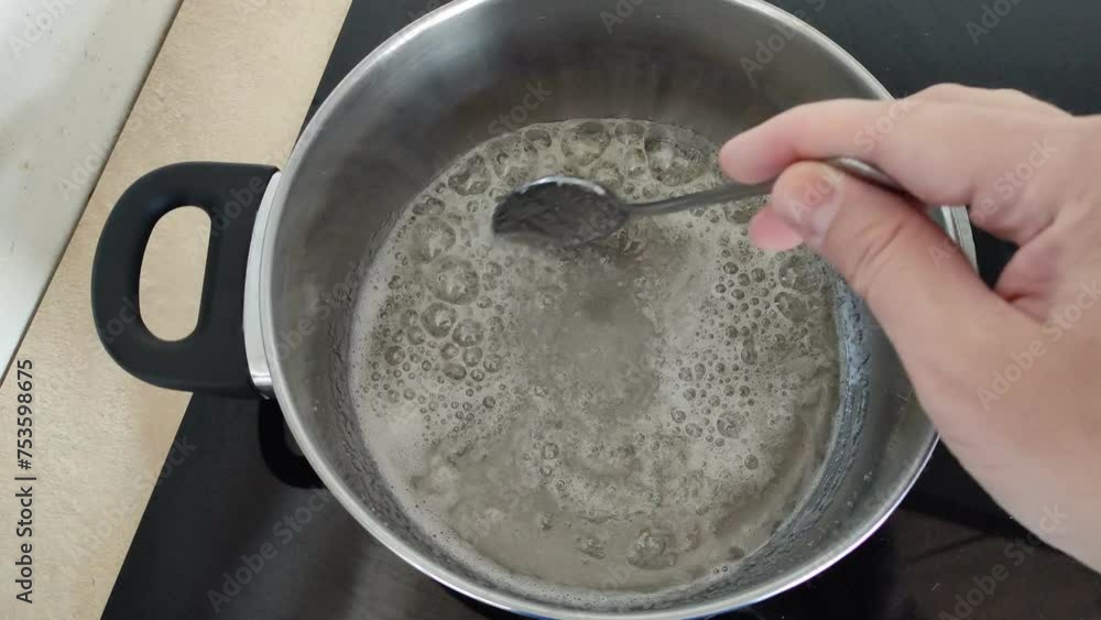 Sugar dissolves in a saucepan on the stove. Making homemade paste for sugaring. Sugar dissolves in a saucepan on the stove. Making homemade paste for sugaring.