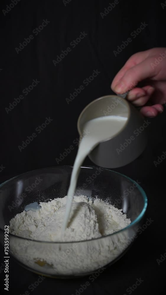 adding milk to flour and eggs to prepare a batter for battered apples adding milk to flour and eggs to prepare a batter for battered apples