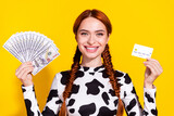 Photo of funky cheerful woman wear cow skin print top comparing cash credit card isolated yellow color background