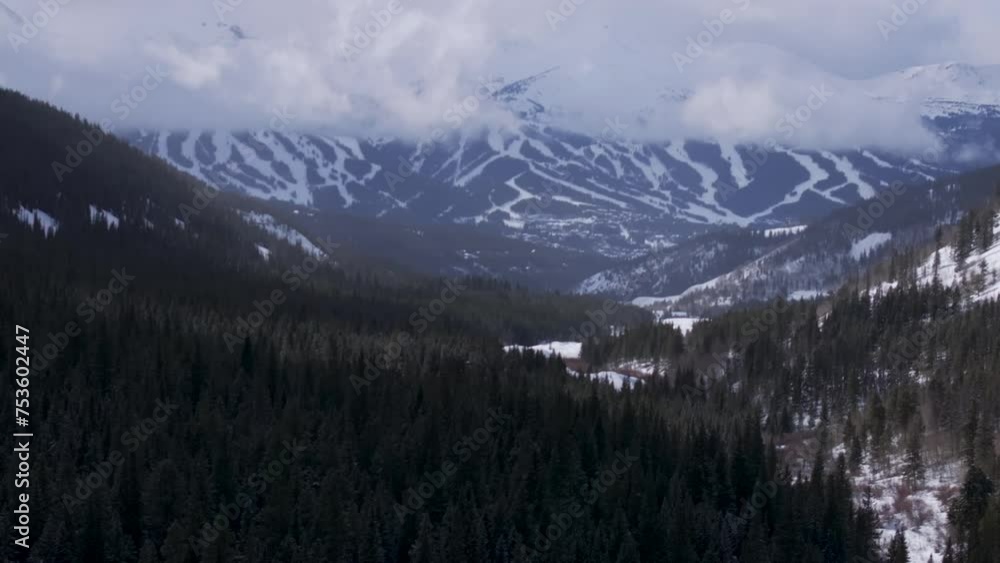 Ten Mile Breck Peaks Breckenridge Ski resort town Vail Epic Ikon Pass aerial drone landscape cloudy fog sunny winter morning ski trail runs Summit County Tiger fork road Rocky Mountains pan up forward Ten Mile Breck Peaks Breckenridge Ski resort town Vail Epic Ikon Pass aerial drone landscape cloudy fog sunny winter morning ski trail runs Summit County Tiger fork road Rocky Mountains pan up forward