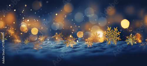 Cozy Christmas golden snowflakes on the snow background with yellow and blue bokeh hues. Festive, uplifting wallpaper backdrop