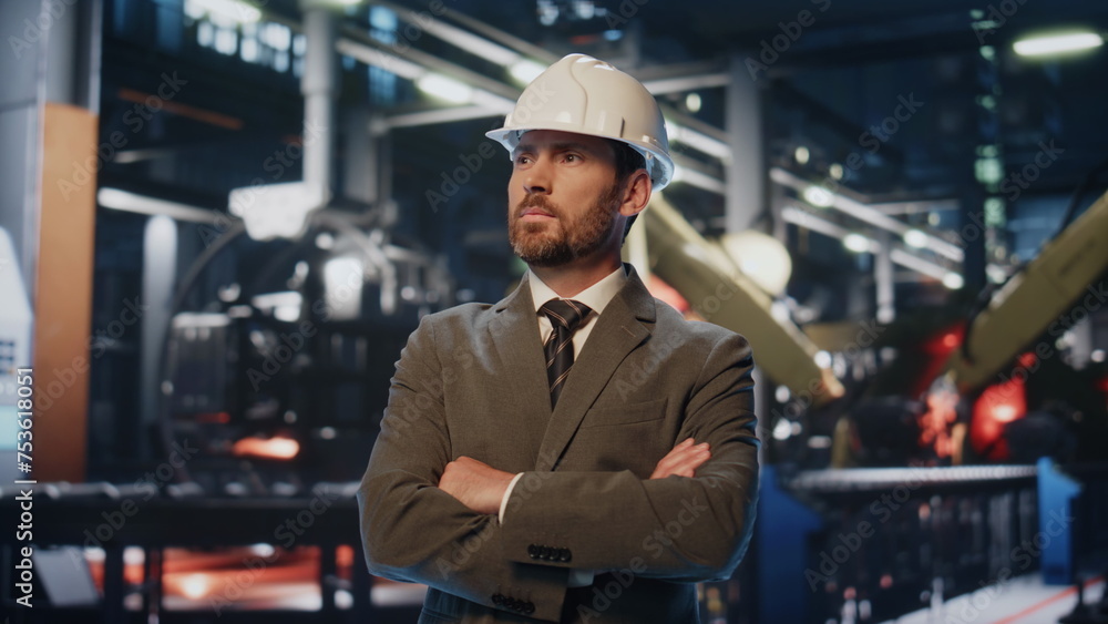 Successful factory owner posing at modern heavy industrial machinery close up. Successful factory owner posing at modern heavy industrial machinery close up.