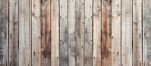 Aged wooden surface with long boards aligned. Wood planks on wall or floor with grain and texture. Faded light neutral tones.