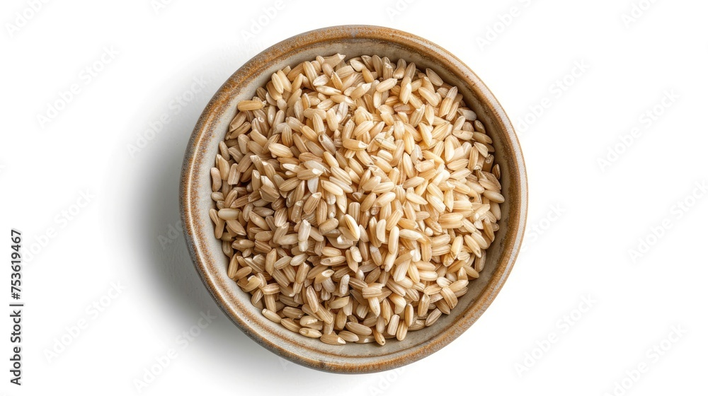 Bowl of uncooked brown rice on a white background.