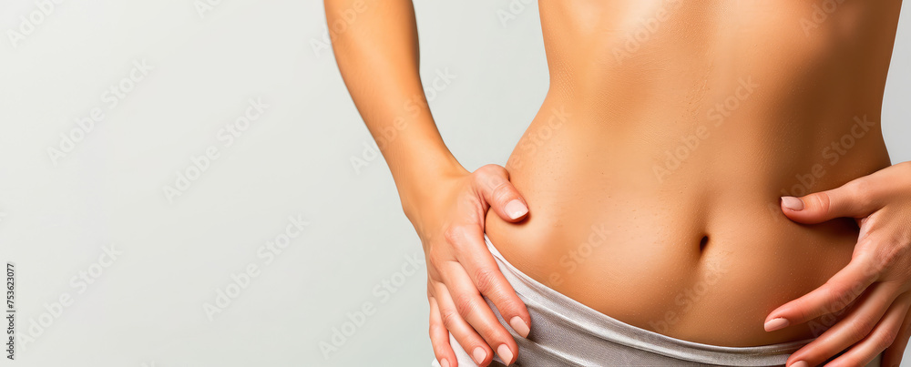 Close-up of a female belly slim beautiful, copy space. Losing weight, a course of exercises for tummy tuck. - obrazy, fototapety, plakaty 
