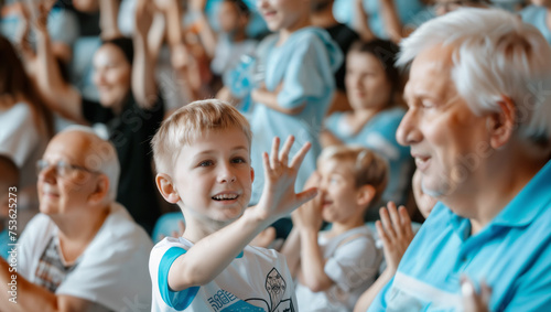 A boy with his grandfather at the stadium proudly shows him that his beloved team has scored five goals.