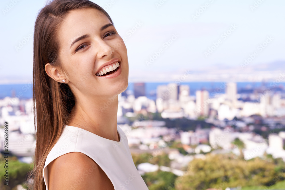 Portrait, smile and woman with balcony, home and view of city skyline and sea. Real estate agent, business and cityscape with ocean, sunshine and happiness on terrace with urban bay for career