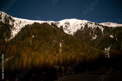 Snow-capped mountain with stars in the sky