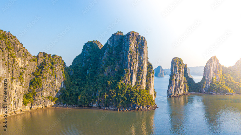 Aerial view floating fishing village and rock island, Halong Bay, Vietnam, Southeast Asia. UNESCO World Heritage Site. Junk boat cruise to Ha Long Bay. Popular landmark, famous destination of Vietnam