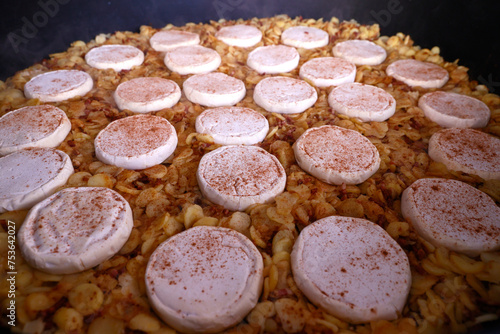 Giant fresh tartiflette, made with Roblochon cheese, potatoes and ham, a speciality in the French Alpes, Saint Gervais, Haute-Savoie, France photo