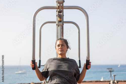 Woman Training at Scenic Seaside Outdoor Gym photo